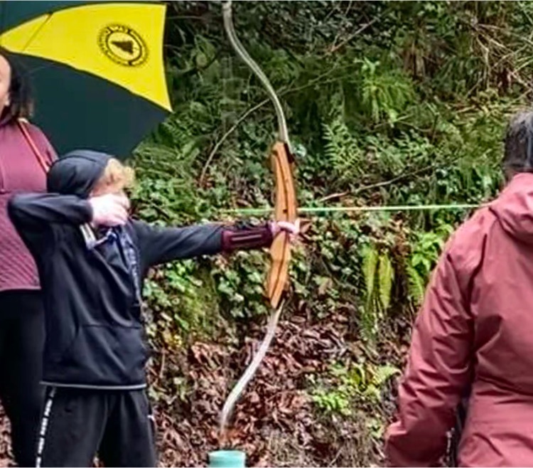 student shooting archery