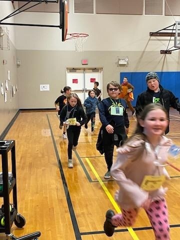 Students pick up speed in the gym portion of the Turkey Trot. 
